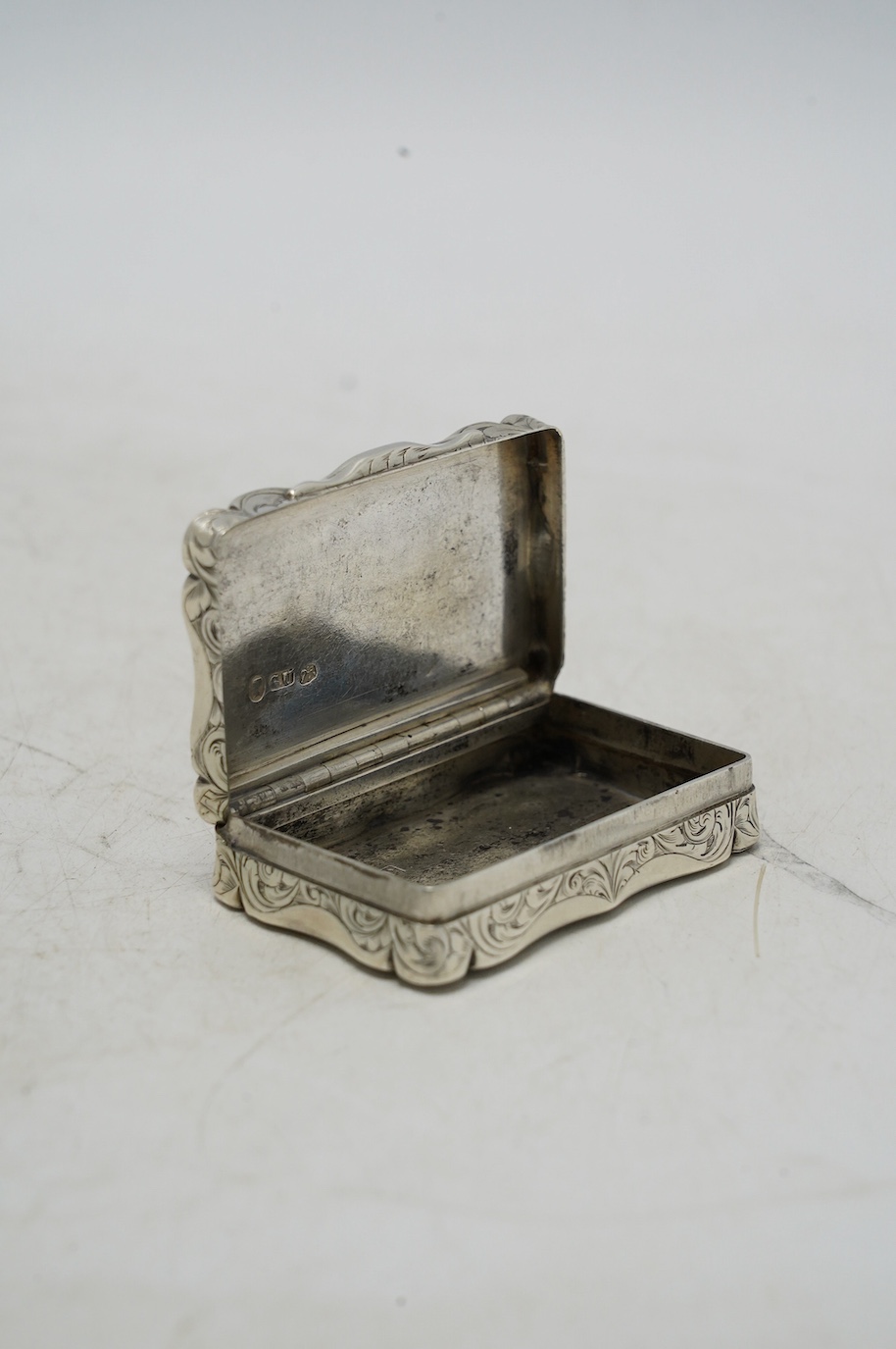 A Victorian engraved snuff box, by George Unite, Birmingham, 1853, 61mm. Condition - fair